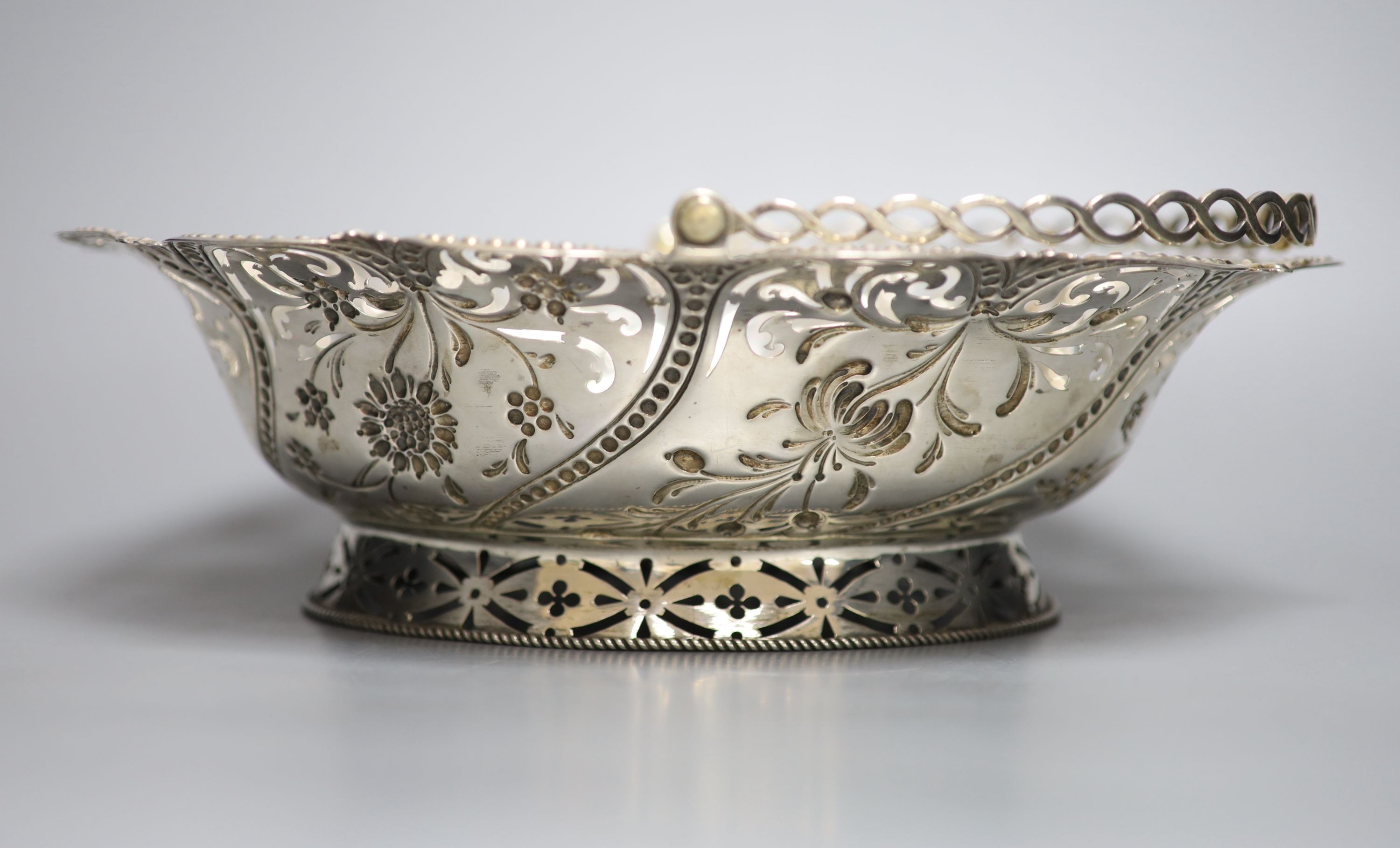 An early George III silver basket, with later? pierced and embossed decoration, Richard Meach, London, 1768, length 30.8cm, 21oz.